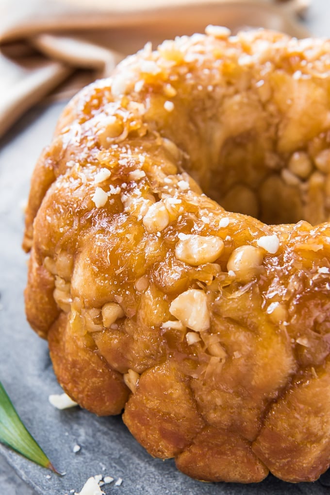 A close up of a loaf of monkey bread with macadamia nuts.