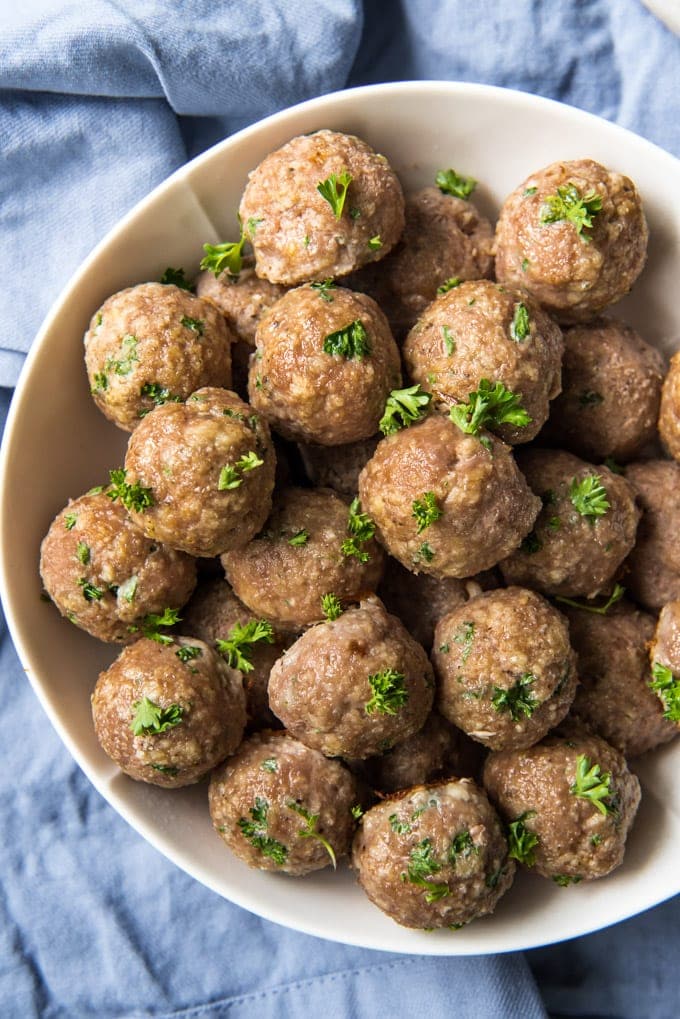 These Ground Turkey Meatballs are tender and moist and a great way to eat healthier without sacrificing flavor! Add them to soups, sandwiches and more! An overhead shot of a bowl of turkey meatballs