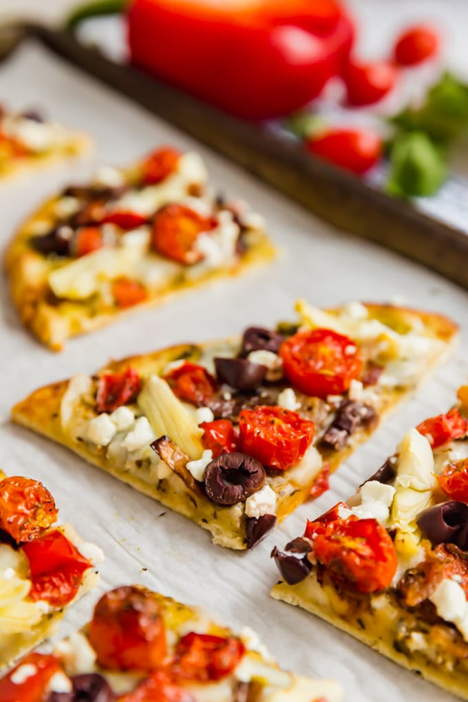 A close up image of a piece of flatbread pizza