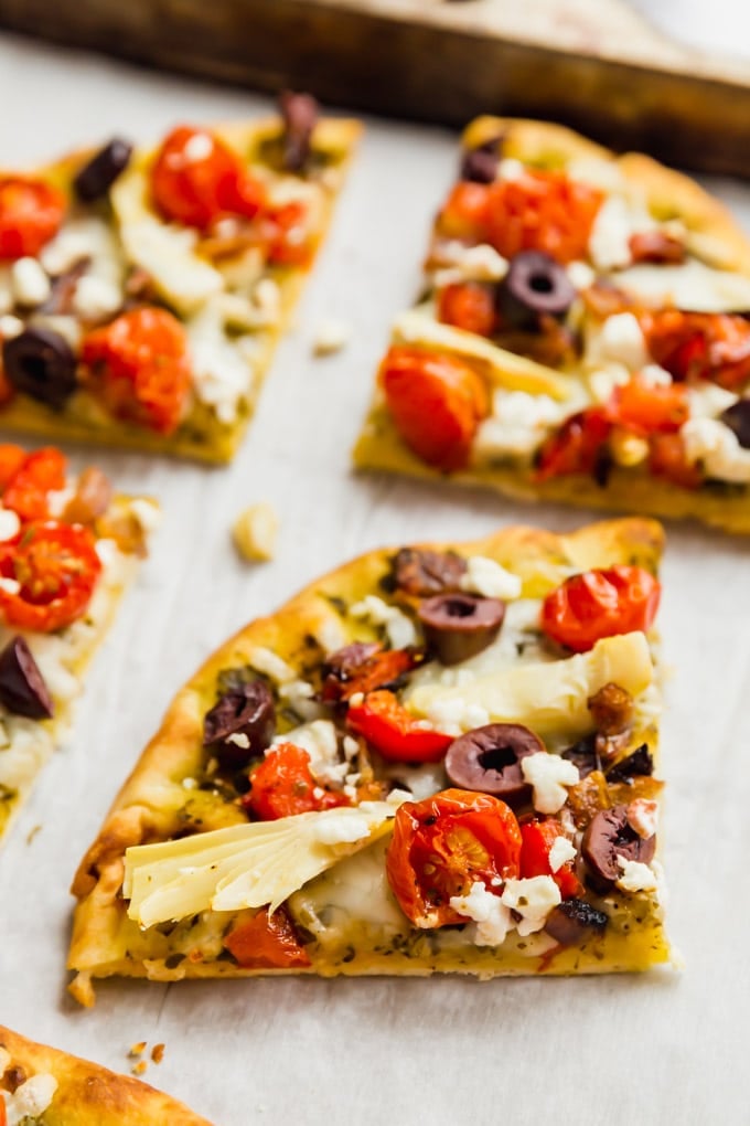 A slice of flatbread pizza on a pan