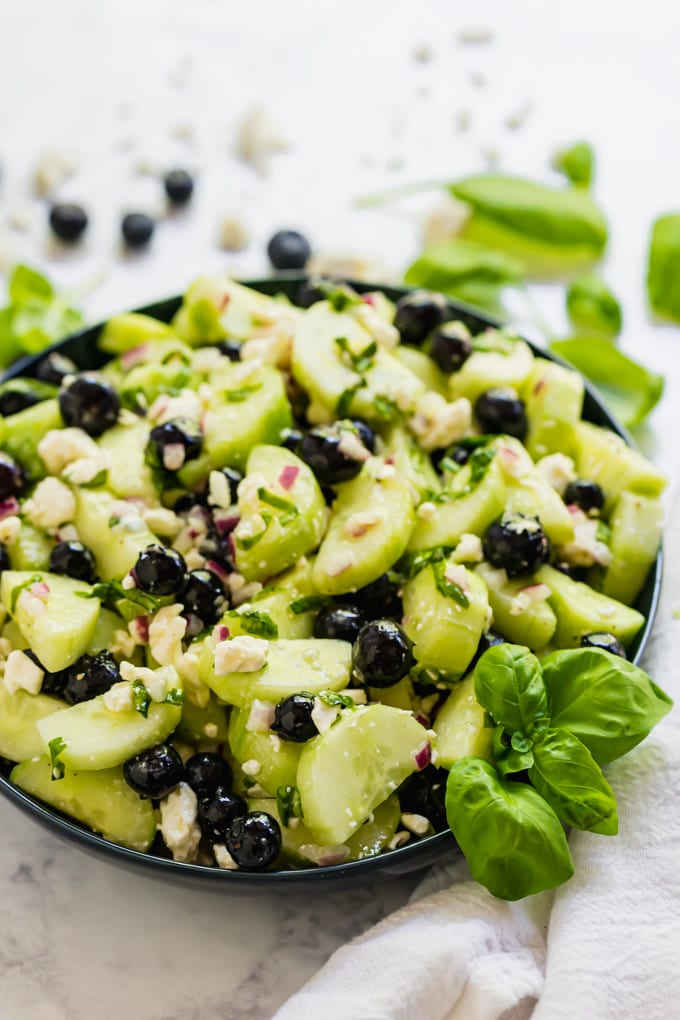 A side angle image of a blow of cucumber salad