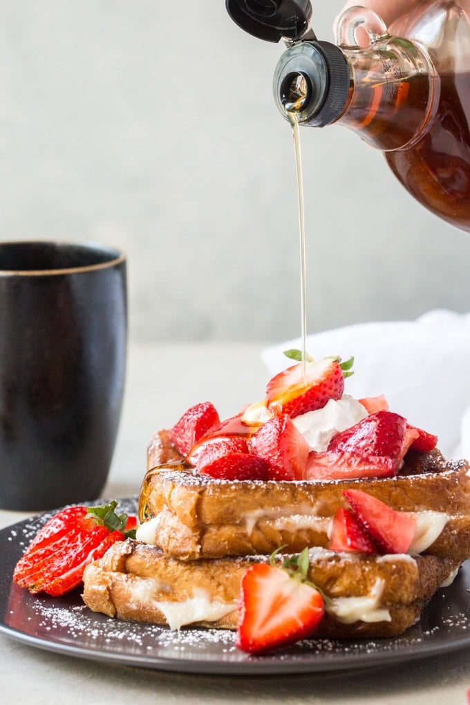 Syrup being poured over cream cheese stuffed french toast