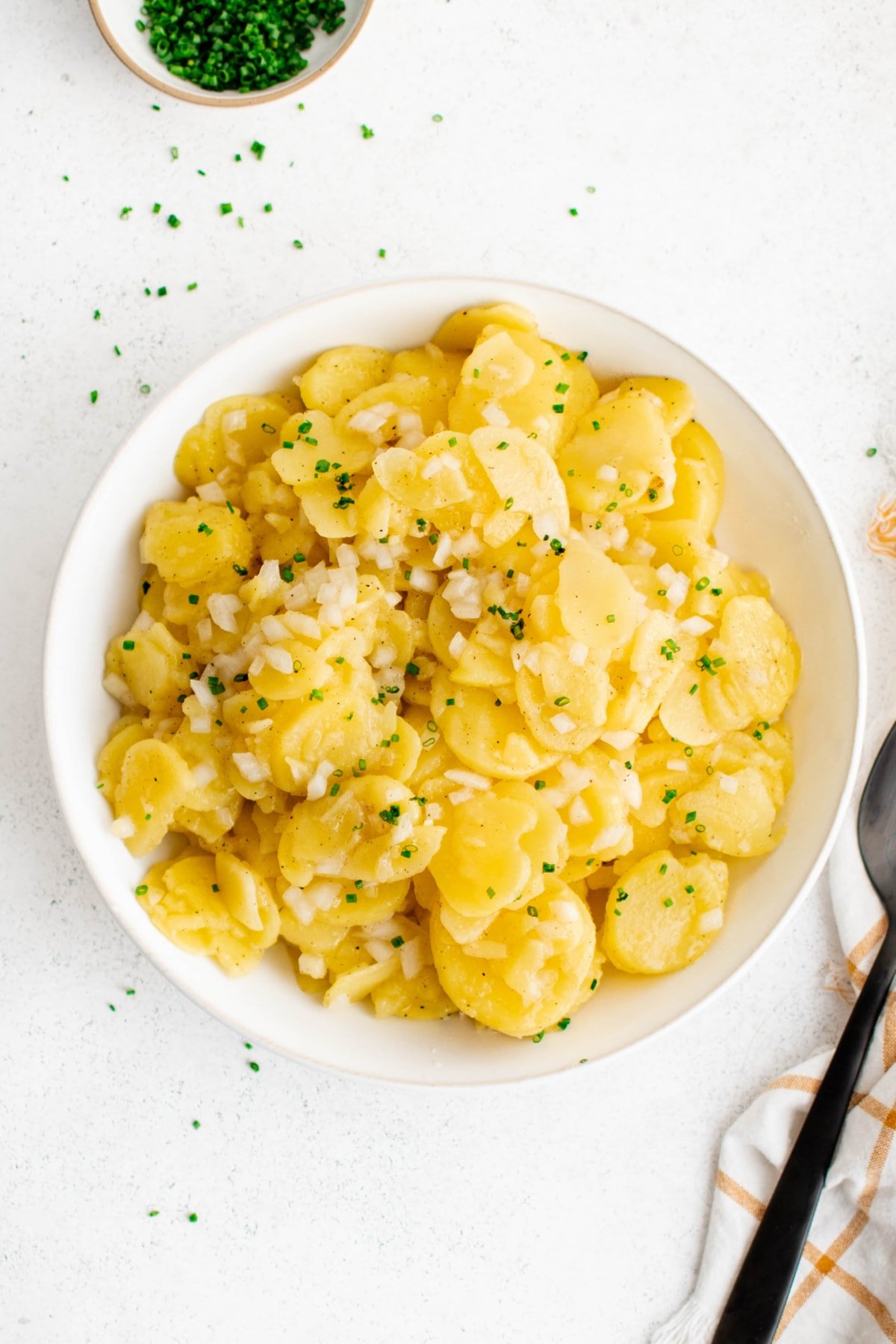 German potato salad on a white dish.