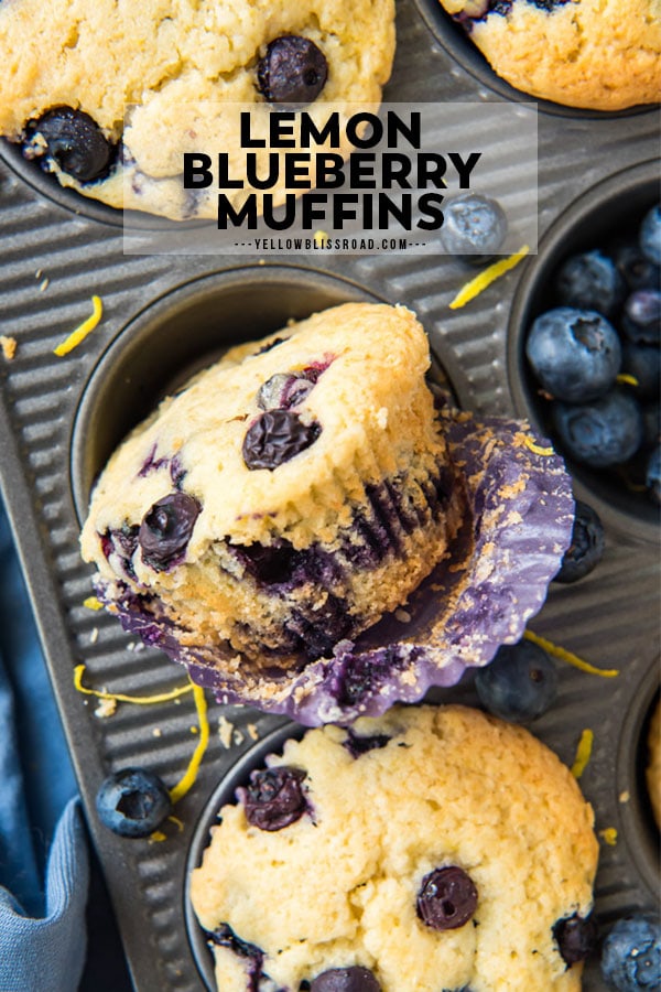 An unwrapped lemon blueberry muffin sits sideways in a muffin pan.