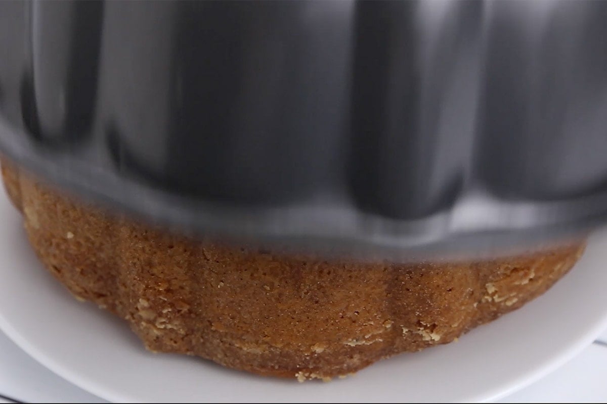 Pound cake being released onto a plate from a bundt pan.