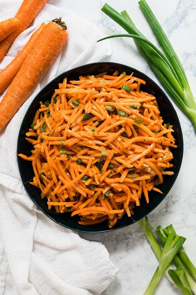 An overhead image of a bowl of carrot salad