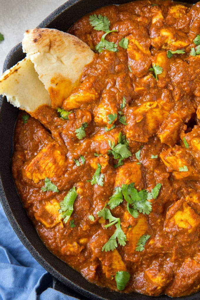 A close up overhead image of chicken in curry sauce.