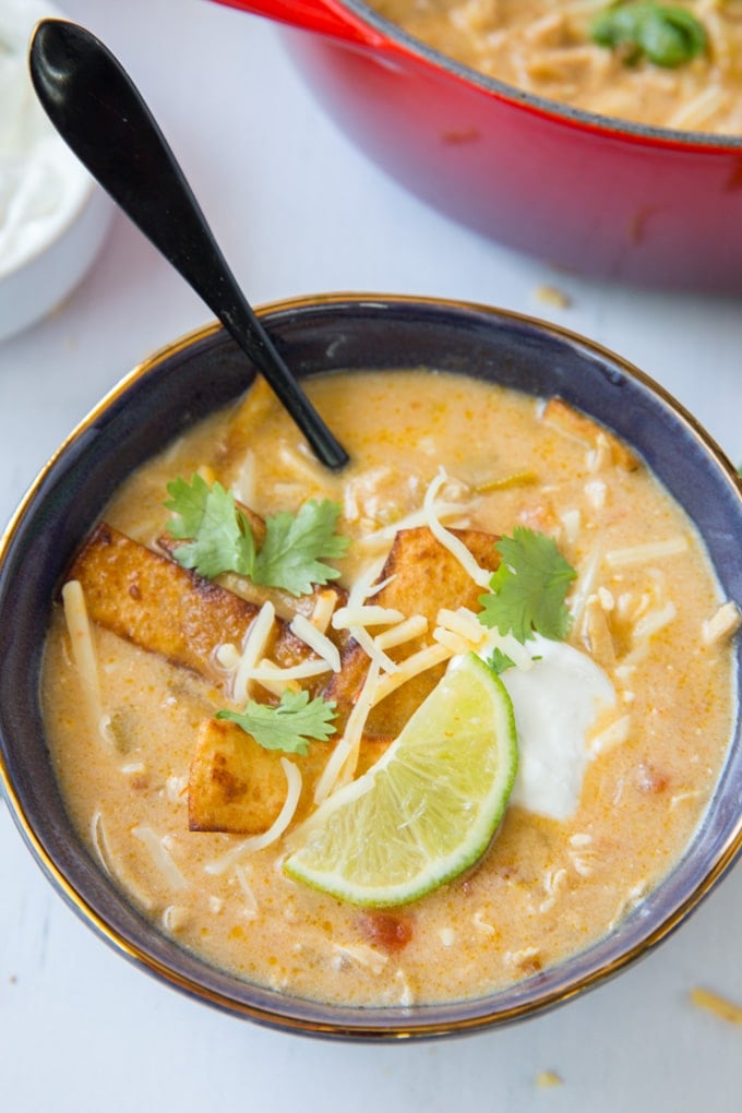 An overhead shot of a bowl of chicken enchilada soup