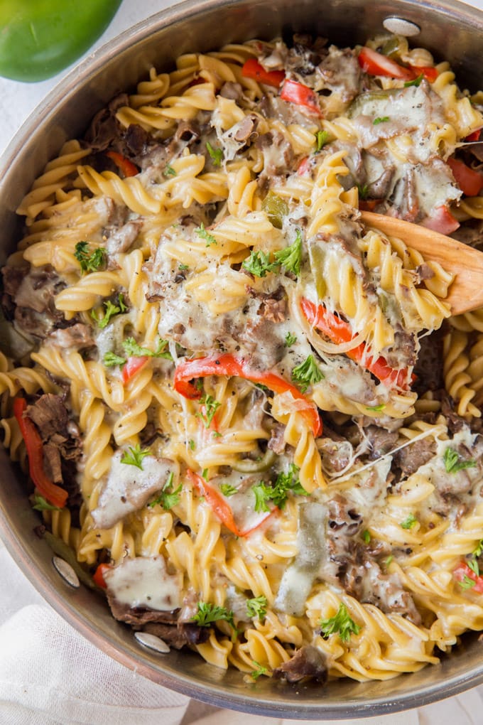 Philly Cheesesteak Pasta one pan dish with a wooden spoon in it