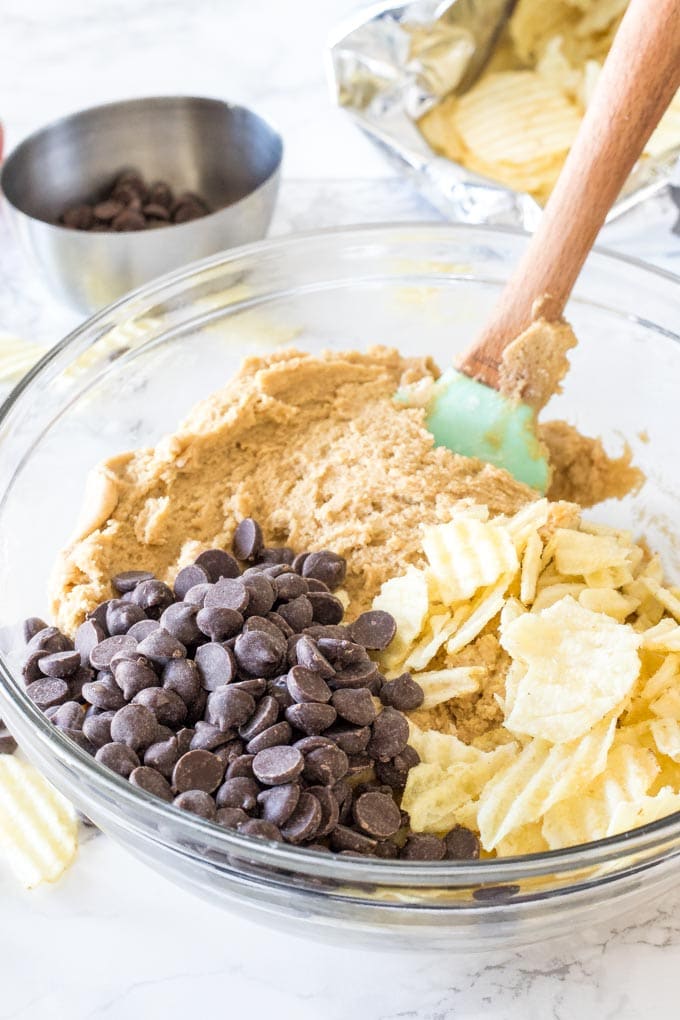 A bowl of cookie dough before the chocolate chips and potato chips are stirred in to make potato chip cookies