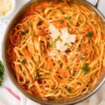 A close up of Red Pepper Fettuccine with parmesan on top.