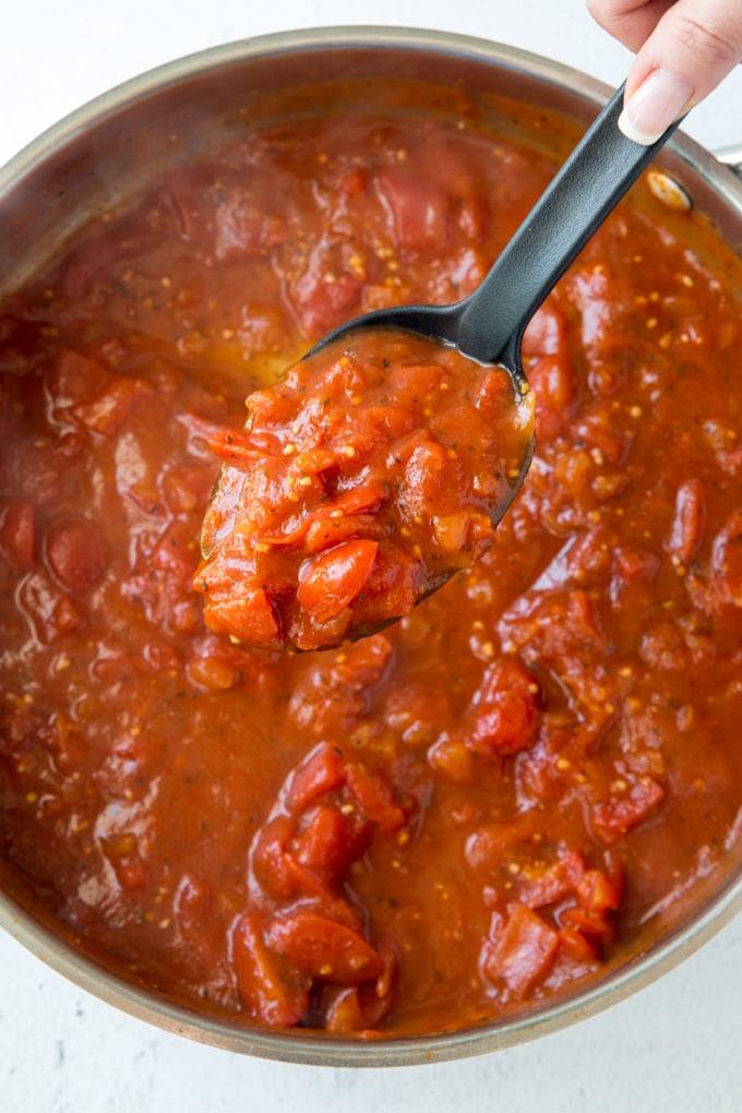 A pan filled with marinara sauce