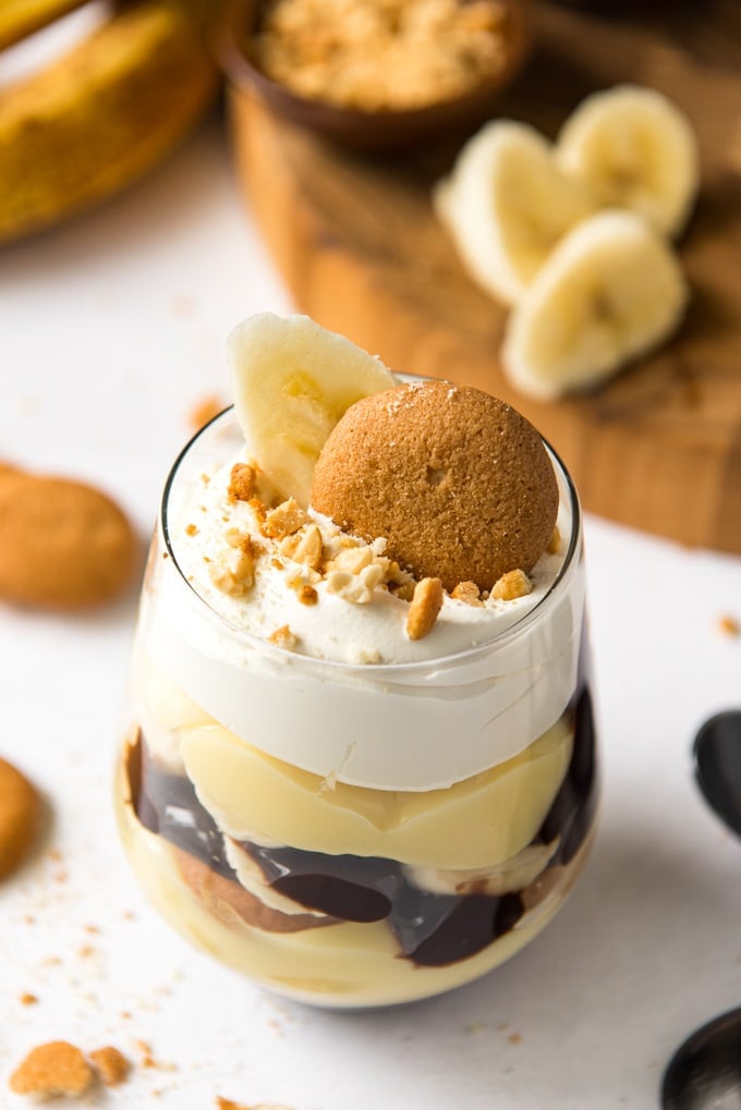 banana pudding layered with chocolate and peanuts in a glass
