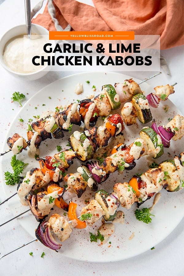 Garlic Lime Chicken Kabobs are perfect for grilling season! Chicken and veggies drizzled with a tangy, creamy garlic lime dressing are the perfect dinner. Chicken Kebabs with garlic lime dressing - a pinterest friendly image.