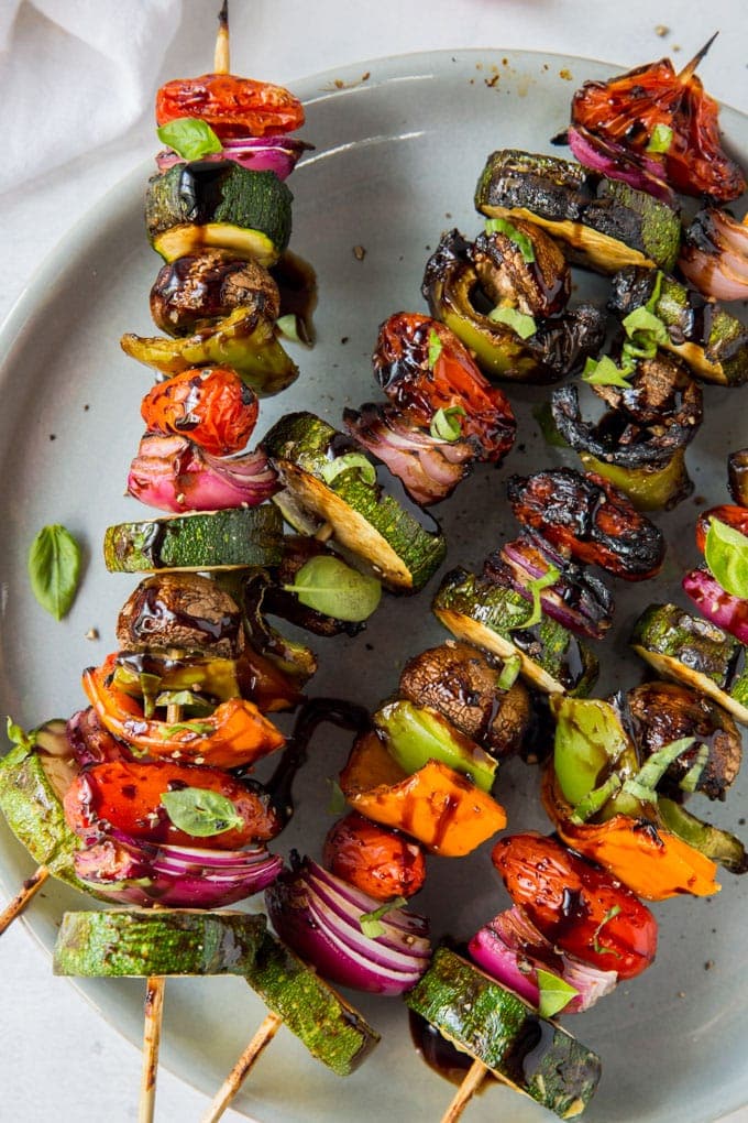 Overhead close up of vegetables threaded on skewers that have been grilled