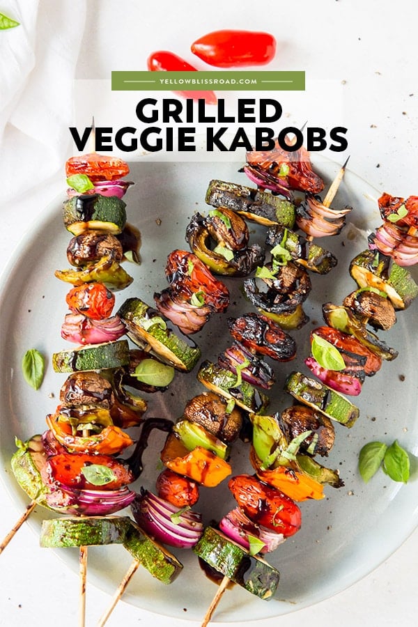 Lots of different vegetables threaded on skewers and coated with a balsamic vinegar glaze - pinterest friendly image with text overlay.