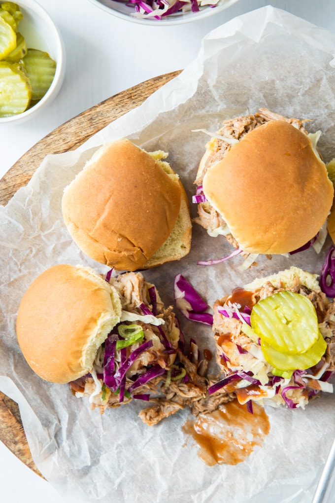 Pulled pork on slider buns topped with coleslaw and pickles