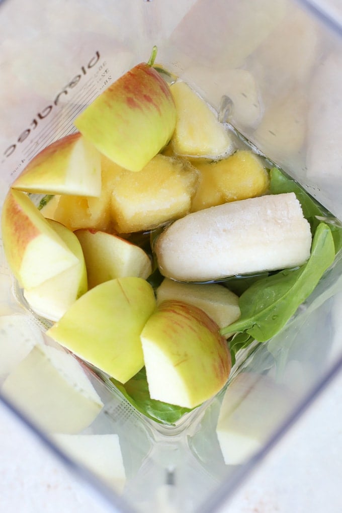 Apple, pineapple, banana and spinach in a blender.