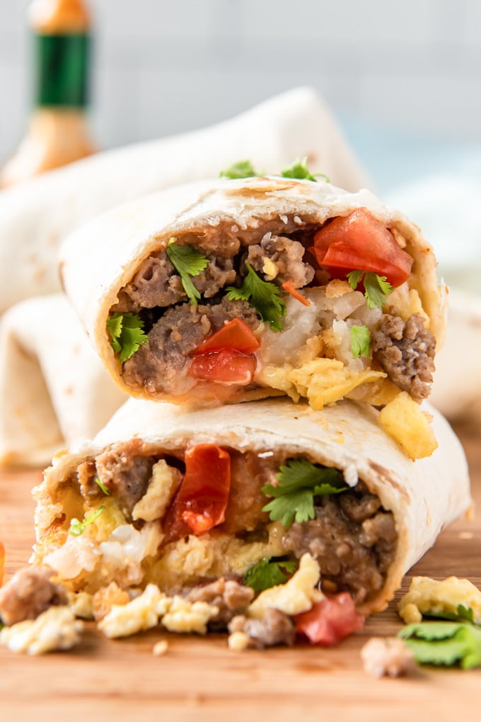 Two halves of a breakfast burrito stacked on top of each other.