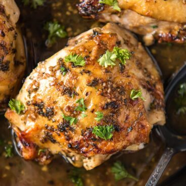 social media image of roasted chicken thighs in cast iron skillet