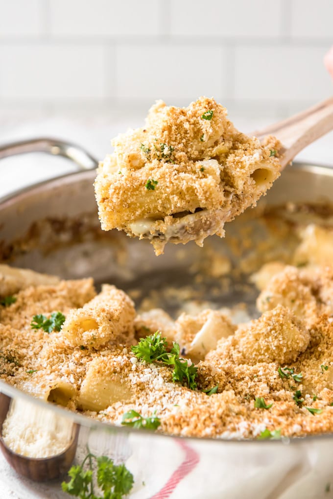 cheesy rigatoni on a wood spoon