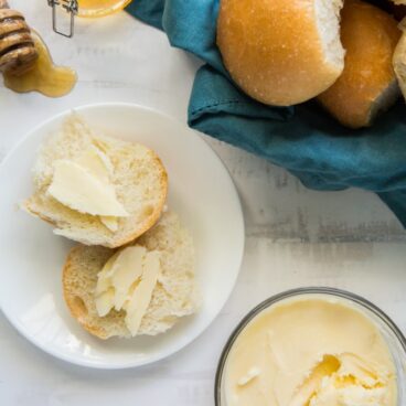 A plate of rolls on a table, with Butter