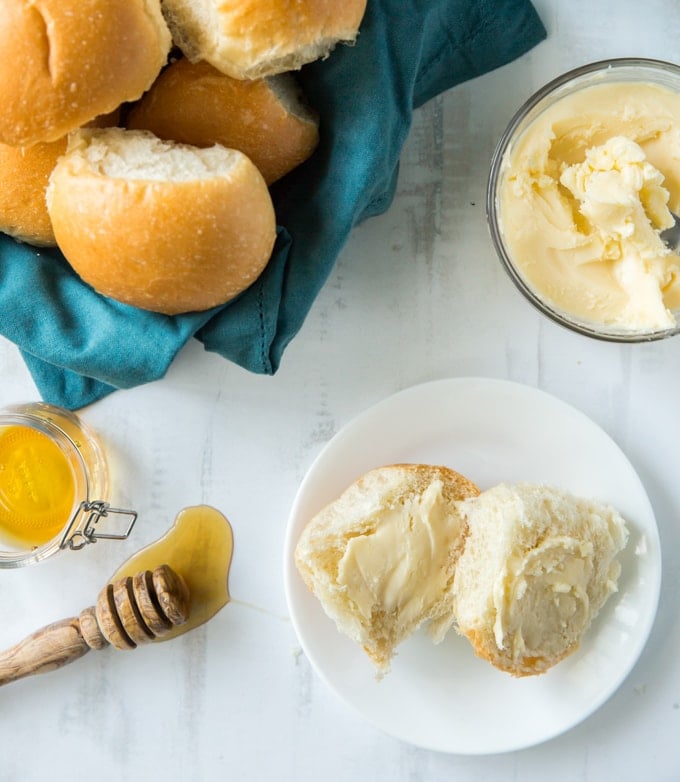 A plate of Rolls, with Butter and Honey