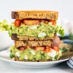 A close up of a plate of avocado egg salad sandwich