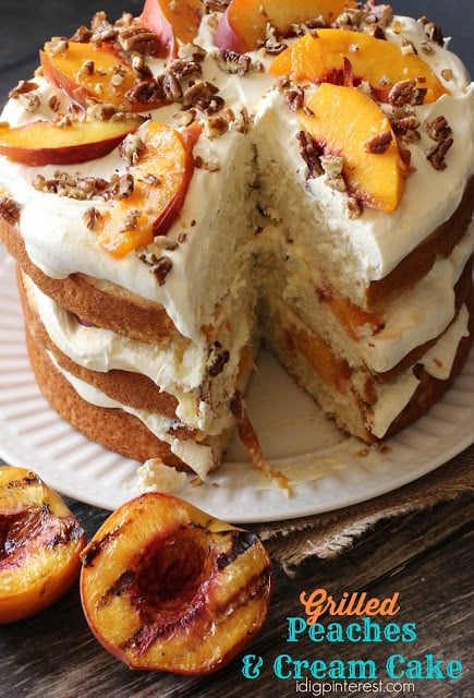 layered cake with white frosting and peaches