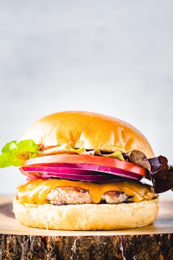 Turkey burger on rustic wooden board.