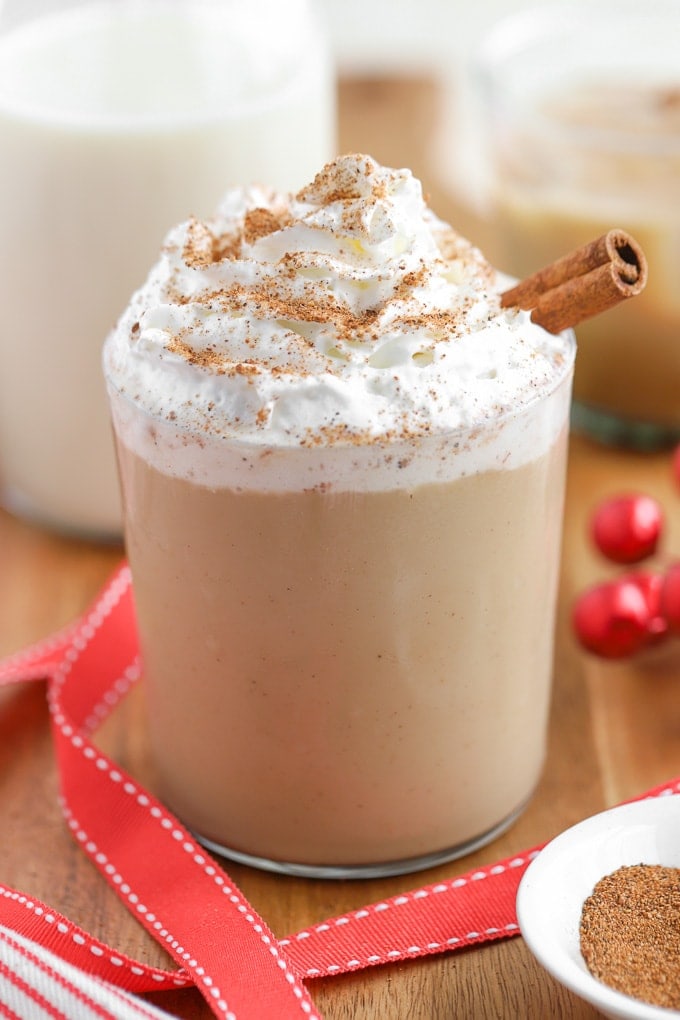 Eggnog White Russian Cocktail topped with whipped cream and a cinnamon stick.