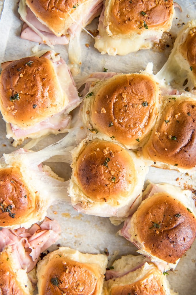 an overhead shot of baked sliders with ham and cheese