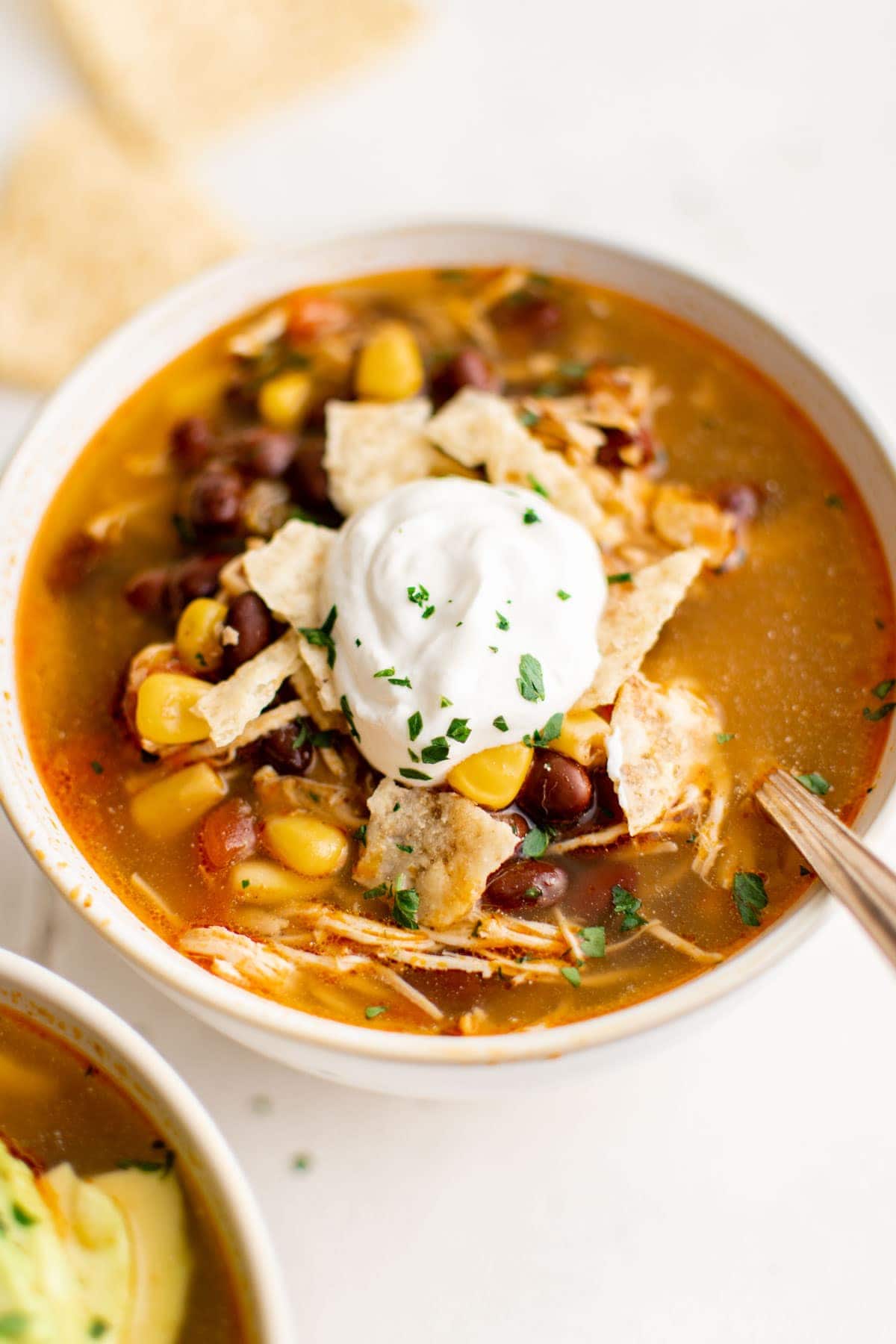 bowl of chicken tortilla soup with sour cream