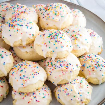 Italian Ricotta Cookies are a fluffy treat that begs to be eaten! Top them with your favorite seasonal sprinkles for an irresistible cookie perfect for the holidays!