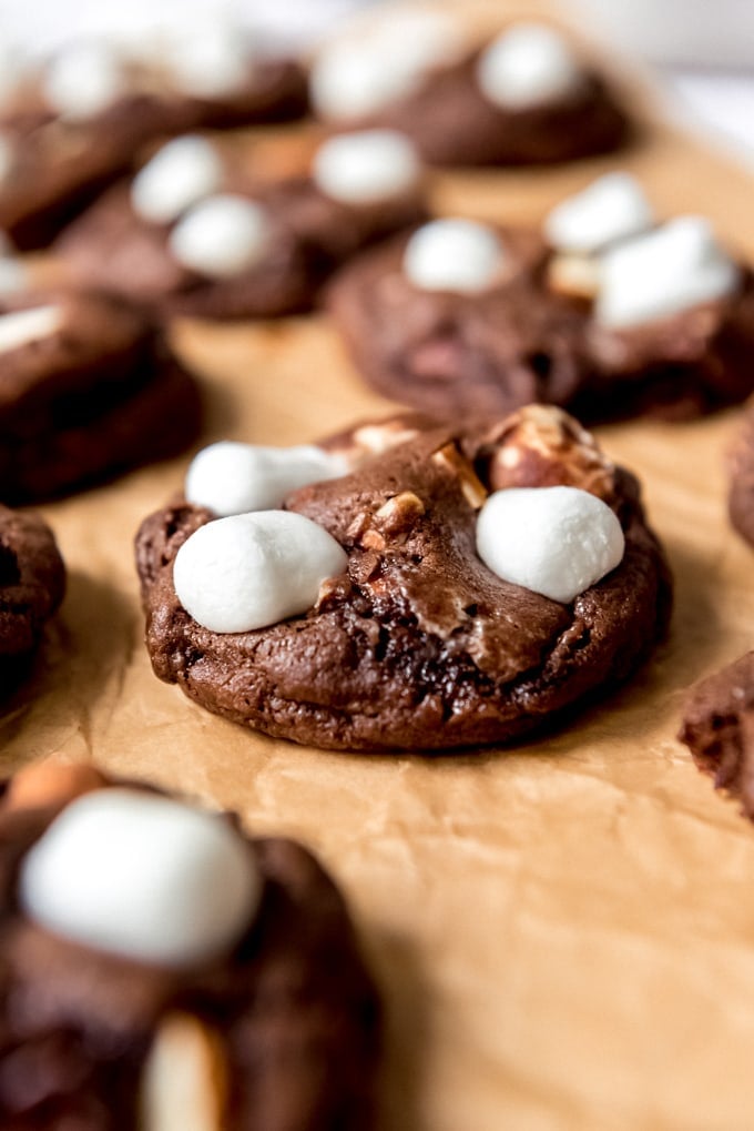 An image of a soft rocky road cookie with chocolate base, marshmallows, and almonds.