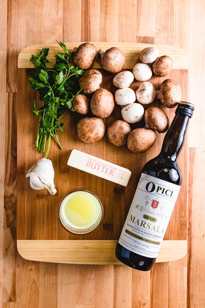 Ingredients shown on cutting board: parsley, mushrooms, garlic, butter, chicken stock, Marsala wine.