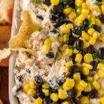 A close up of southwest dip with beans and corn