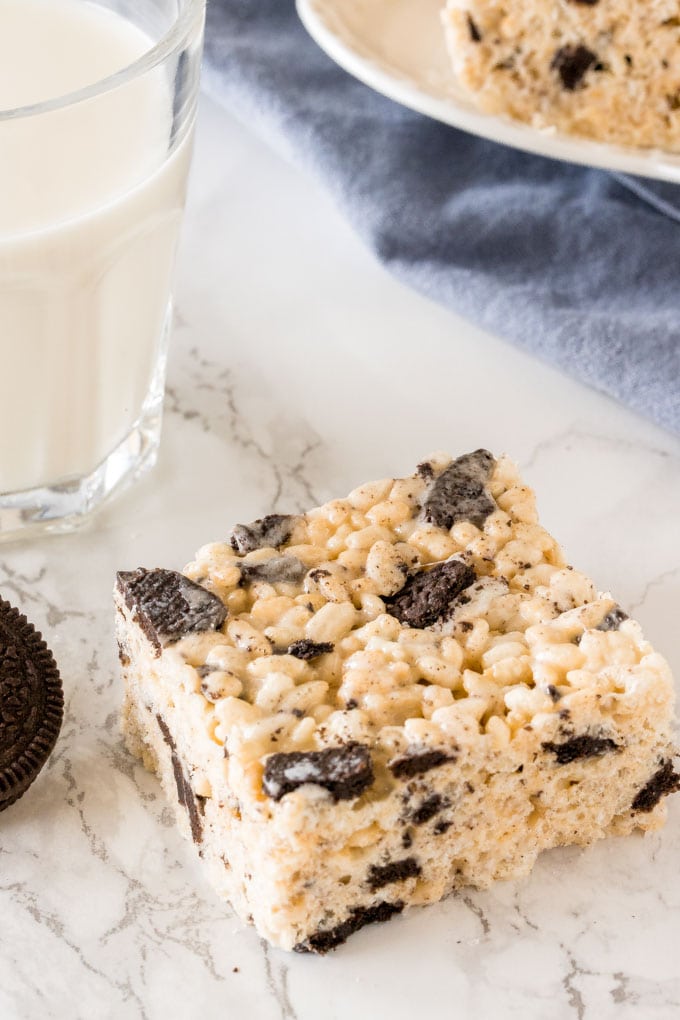 An Oreo rice krispie treat with a glass of milk