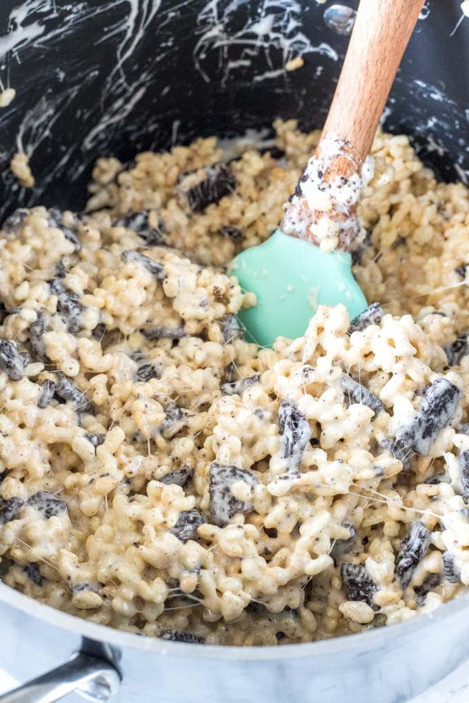 A saucepan of gooey marshmallow mixed with rice cereal and oreos