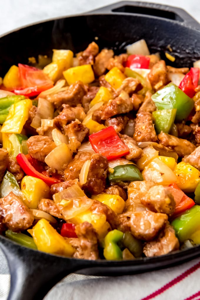 An image of homemade sweet & sour pork in a large pan.