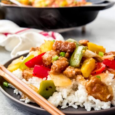 A dish filled sweet and sour pork with rice