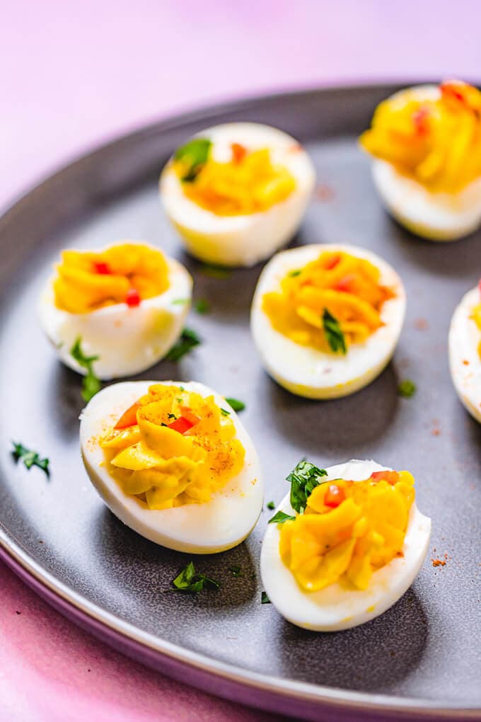 Closeup shot of deviled eggs in grey plate.