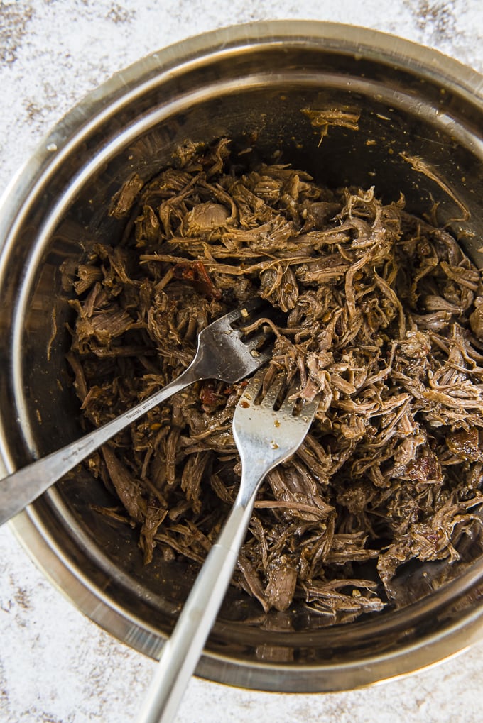 Shredding beef with two forks