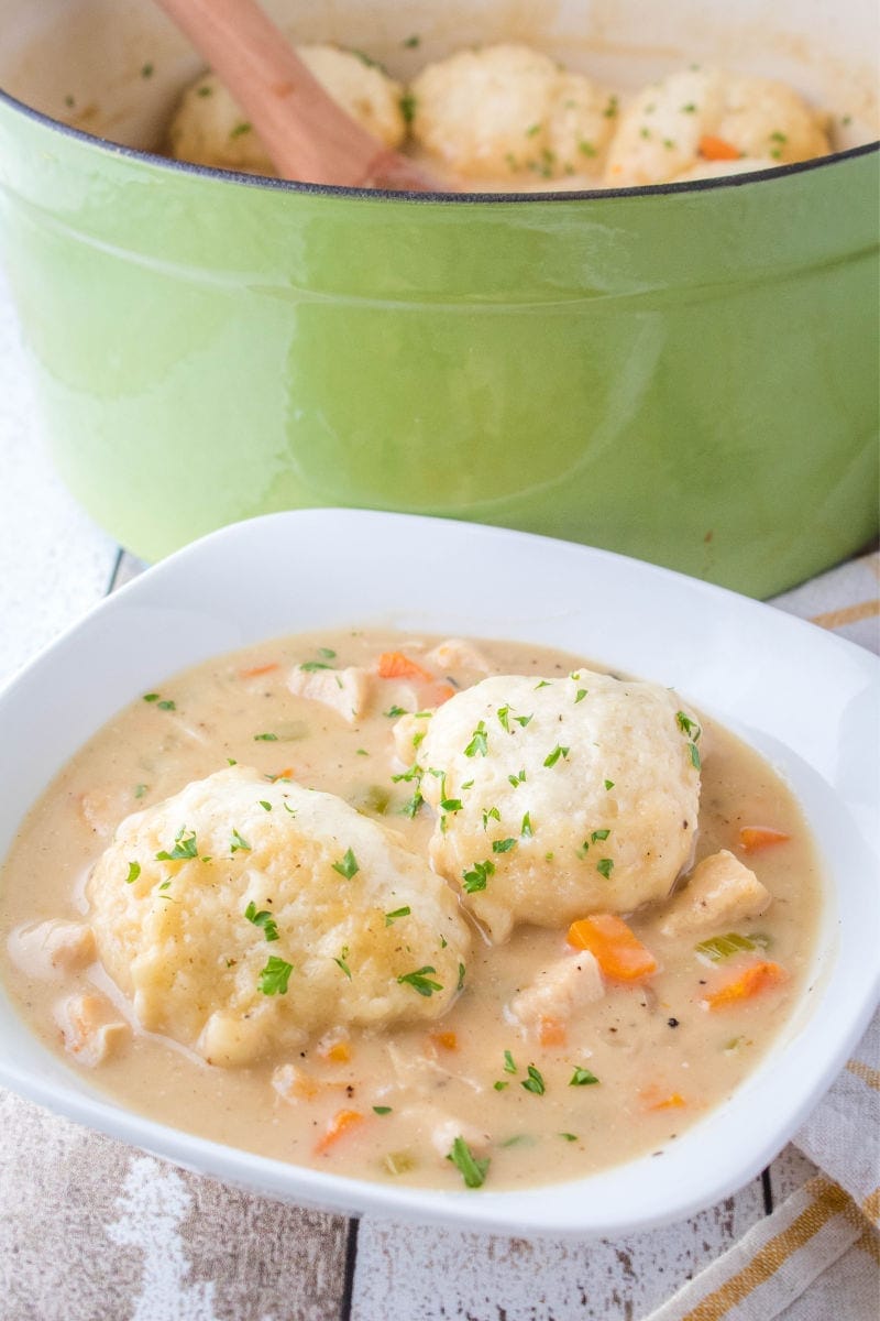 Chicken and Dumplings are a classic comfort food sure to satisfy your soul! Perfect for weeknight meals or Sunday supper with the family! serving of chicken and dumplings in a bowl