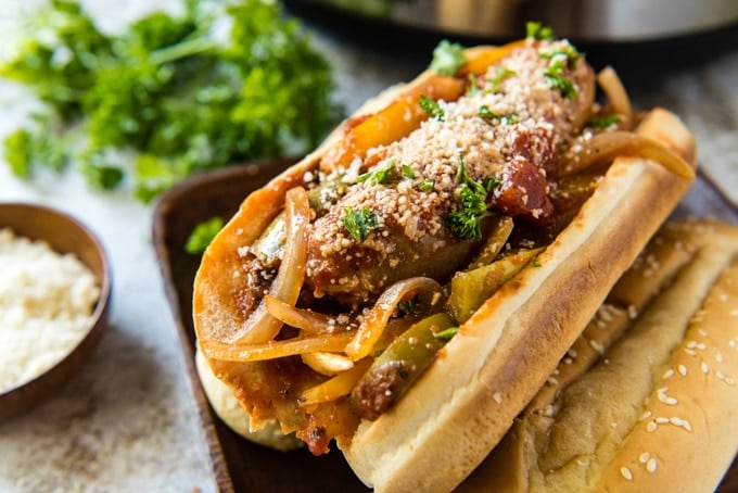 Italian sausage and peppers in hoagies with cheese on top.