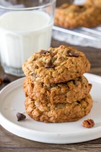A stack of 3 thick and chewy cowboy cookies.