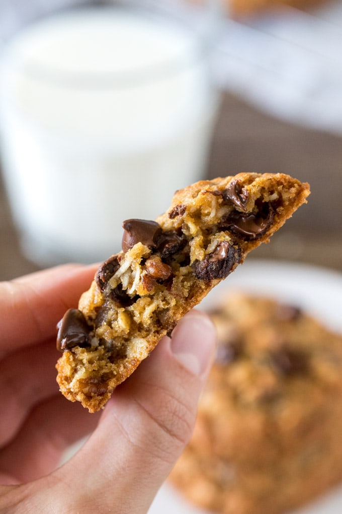 A cookie broken in half, showing the thick, chewy texture. 