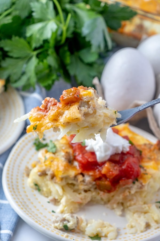 a fork lifting up a bit of egg hash brown casserole