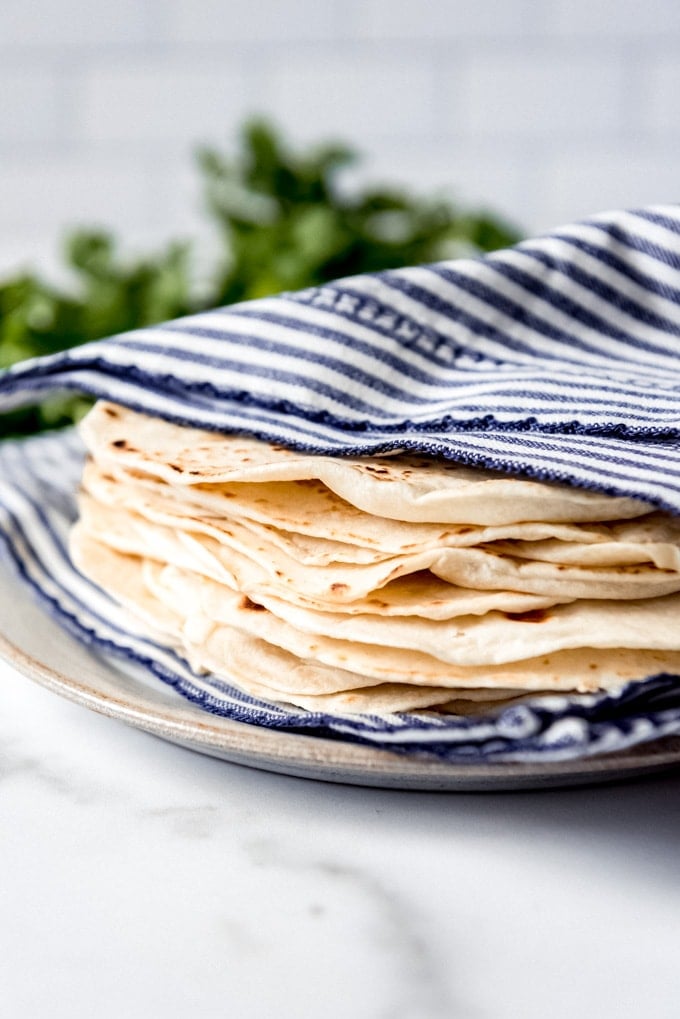 An image of fresh homemade tortillas wrapped in a napkin to stay warm.