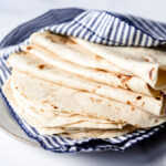 Flour Tortillas wrapped in a blue striped towel